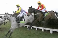 Iris's Gift (AP McCoy) taking one of the Gold Cup fences in front of Sir Rembrandt
